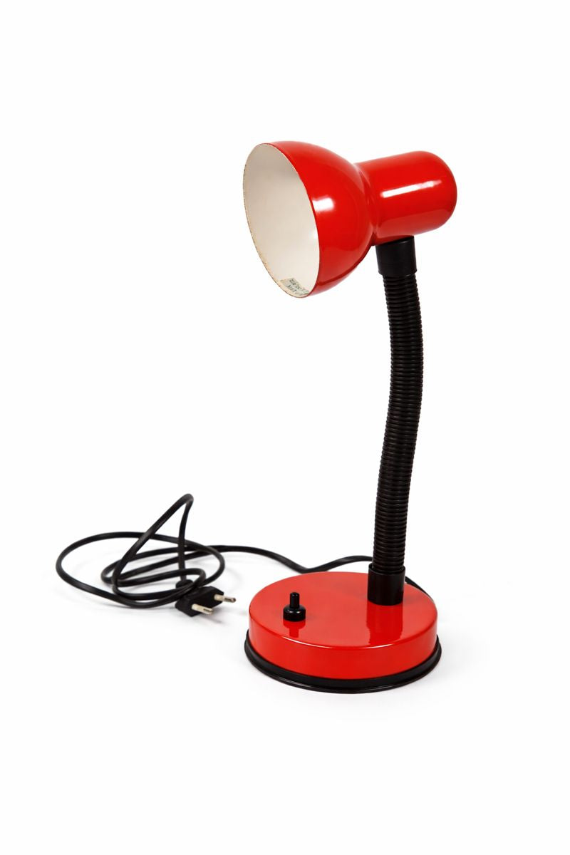 Red desk lamp with flexible neck on a white background
