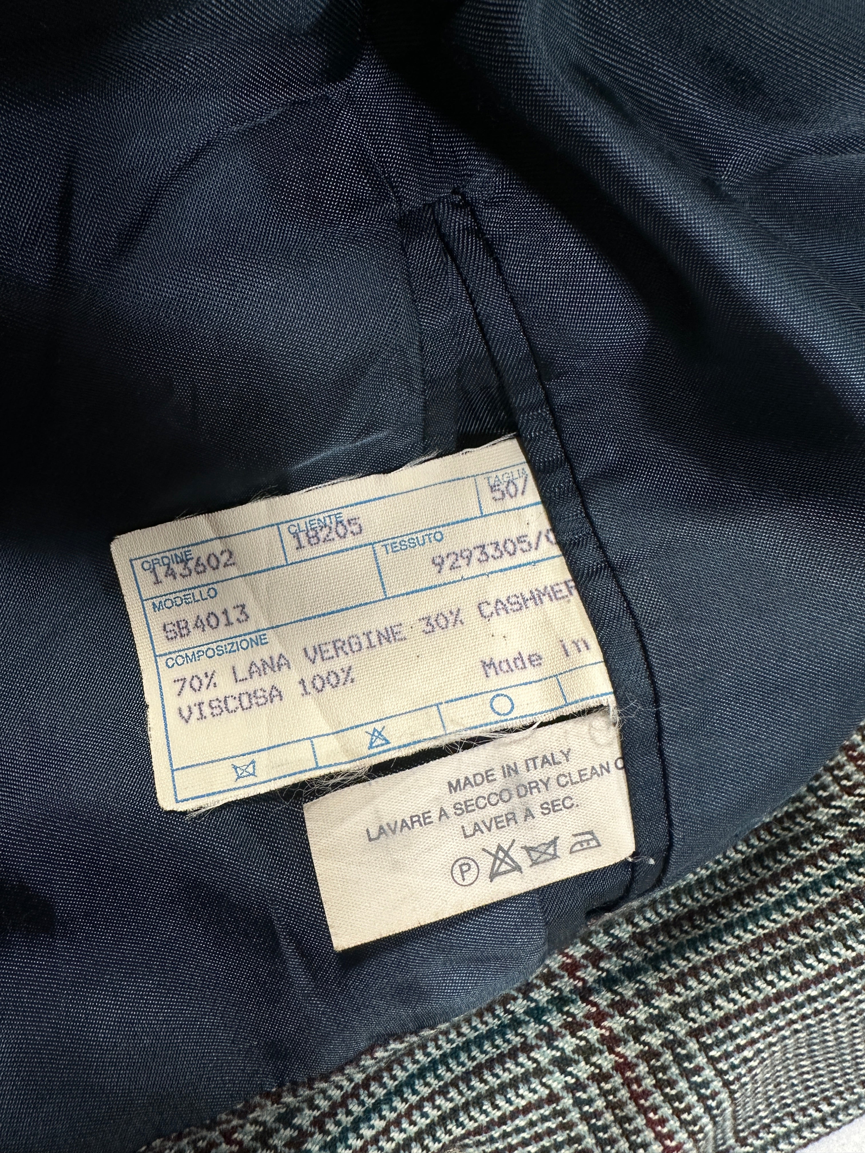 Close-up of a label on a dark fabric garment with visible text and numbers.